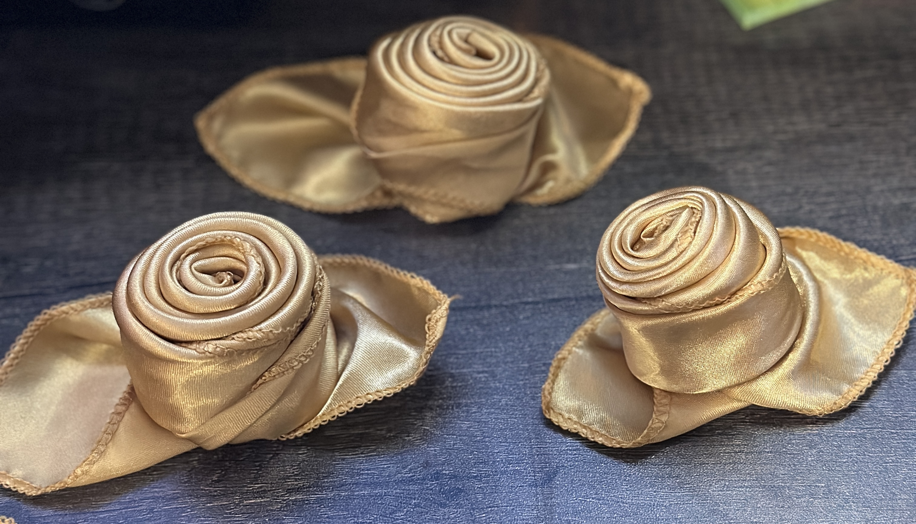 Gold satin rose napkin folds