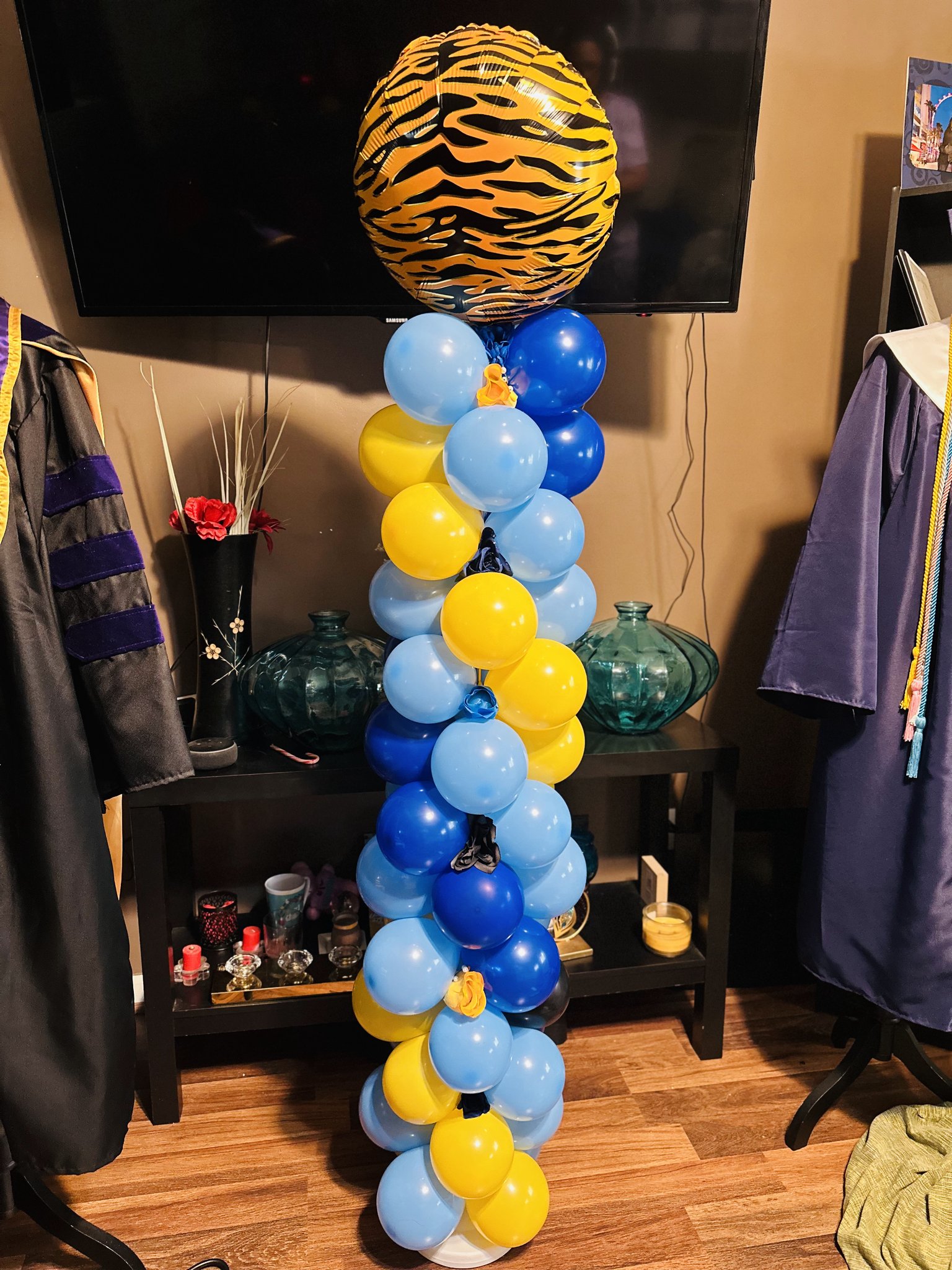 Blue, yellow and gold graduation balloon column with tiger print topper
