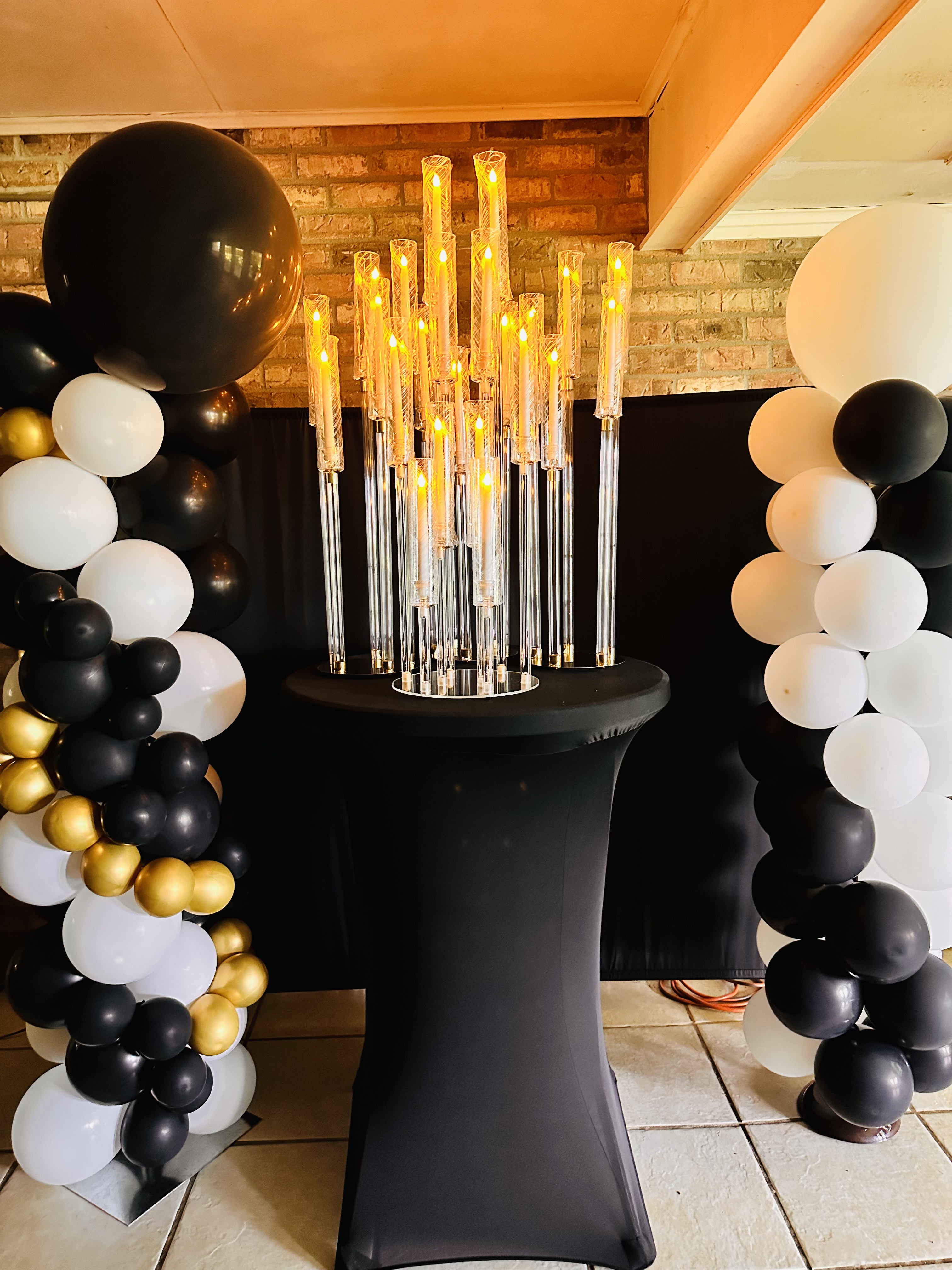 Black, white and gold balloon columns with candelabra centerpiece